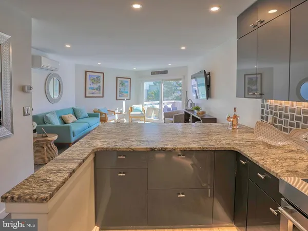 a kitchen with granite countertop a sink and a stove