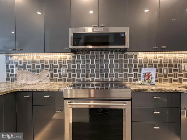 a kitchen with a sink and a stove top oven