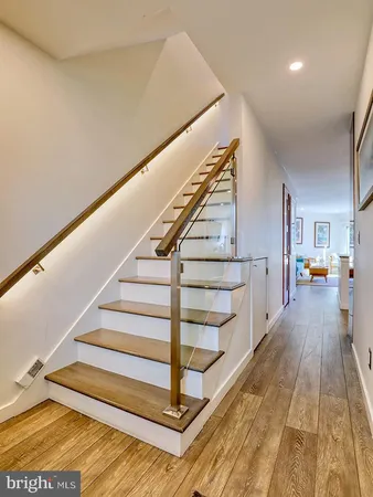 a view of entryway and hall with wooden floor