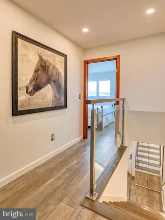 a view of a hallway with a painting on the wall