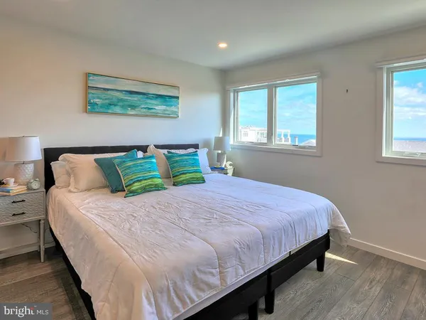a large bed sitting in a bedroom next to a window