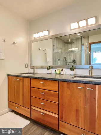 a bathroom with a granite countertop sink mirror and double