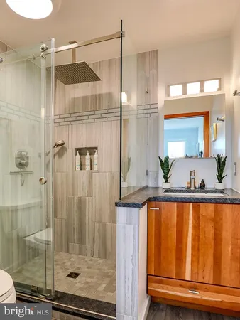 a bathroom with a shower and a sink