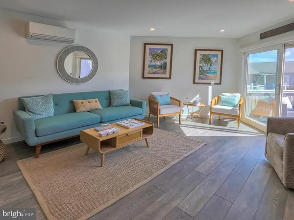 a living room with furniture a rug and a window