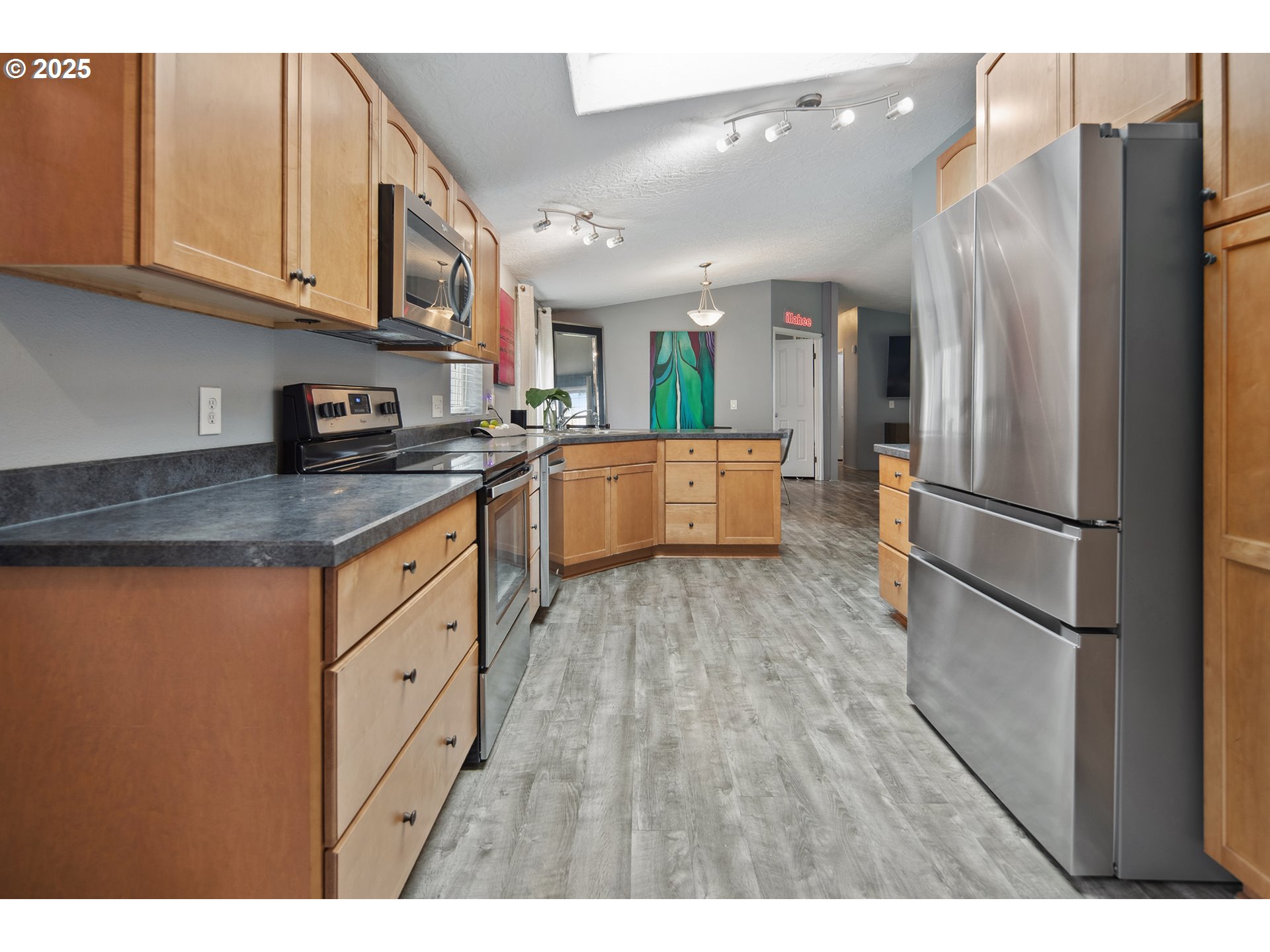34680 Northeast Kramien Road Newberg, OR 97132 - Photo 28 of 40 a kitchen with stainless steel appliances granite countertop a refrigerator sink and cabinets