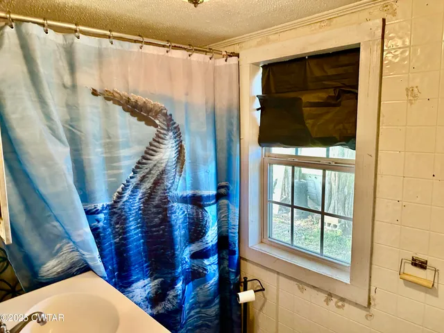 a bathroom with a shower and a tub