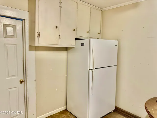 a white refrigerator freezer sitting in a kitchen