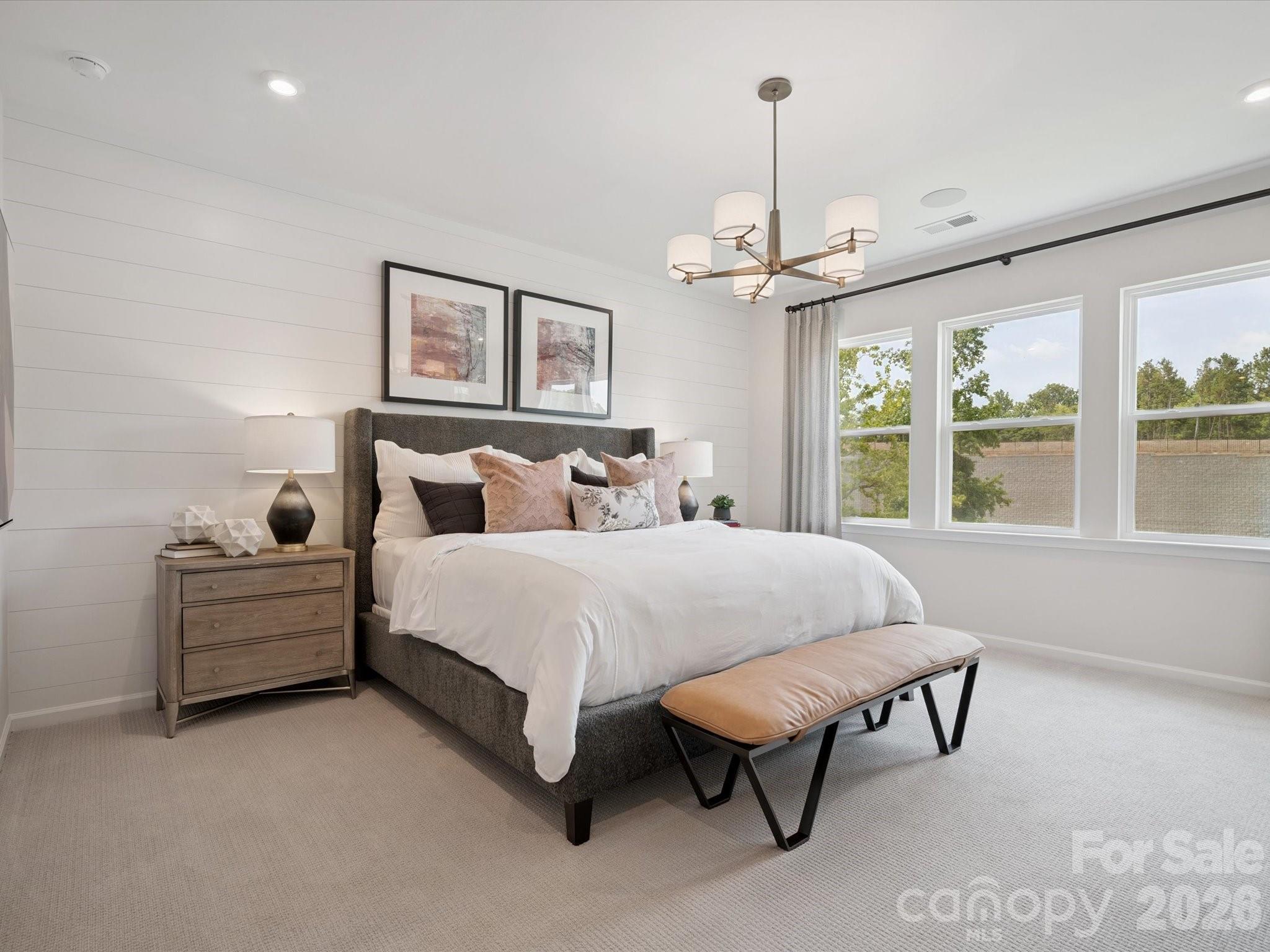 620 Webster Lane Cramerton, NC 28032 - Photo 17 of 19 a bed room with a bed and a chandelier