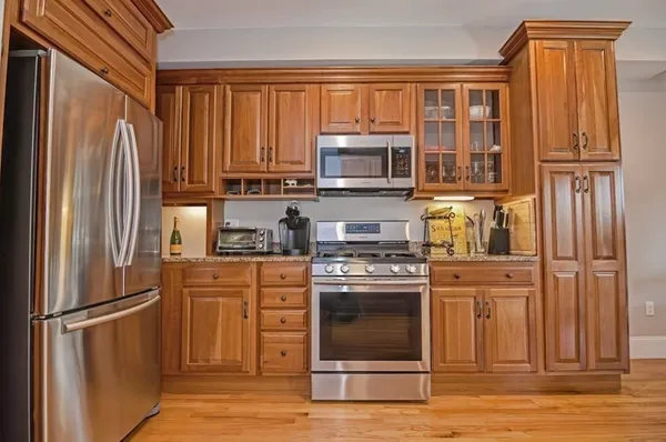 a kitchen with stainless steel appliances granite countertop a refrigerator stove and sink