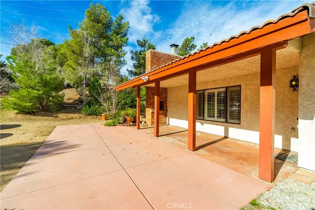 an aerial view of a house with a yard and trees
