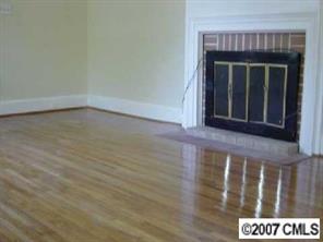 338 Marsh Road Charlotte, NC 28209 - Photo 4 of 7 a view of an empty room with wooden floor and a fireplace