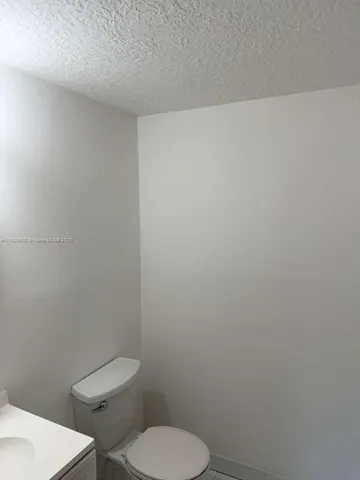 a bathroom with a toilet a sink and shower