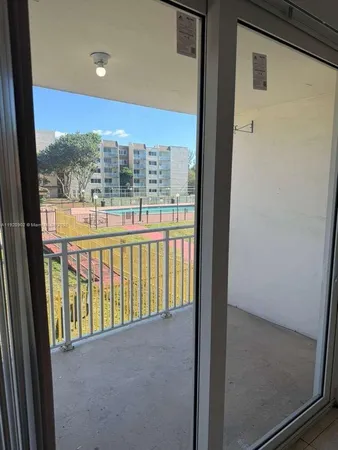a view of a glass door and the balcony