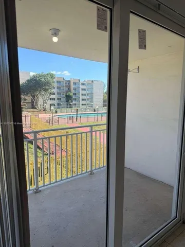 a view of a glass door and the balcony