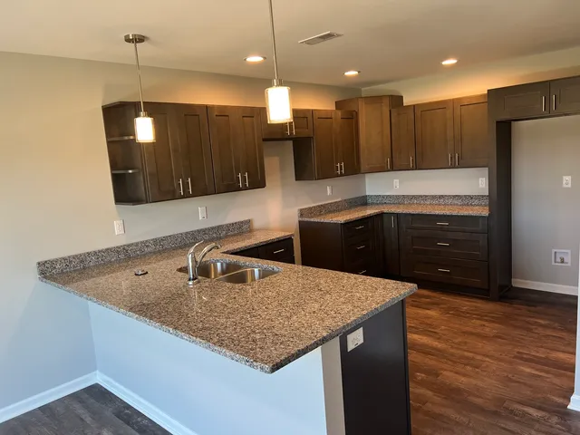 a kitchen with center island and stainless steel appliances