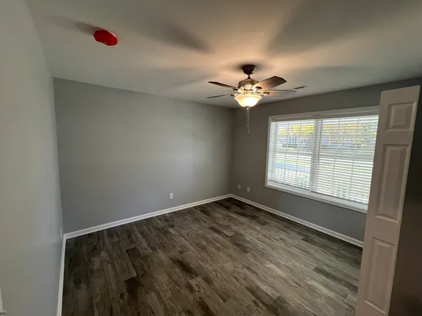 wooden floor in an empty room with a window