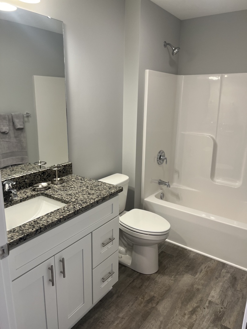 1107 South 2nd Street Oregon, IL 61061 - Photo 7 of 10 a bathroom with a double vanity sink toilet and shower