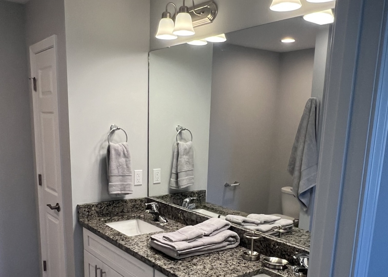 1107 South 2nd Street Oregon, IL 61061 - Photo 9 of 10 a bathroom with a granite countertop sink a toilet and a mirror