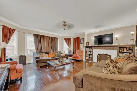 a living room with furniture fireplace and flat screen tv