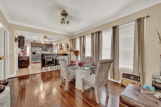 a view of a dining room with furniture and wooden floor