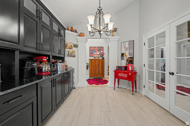3034 Swiss Drive Santa Clara, UT 84765 - Photo 23 of 59 Spacious hallway featuring light-colored wood-finish tile flooring, white walls, and a chandelier light fixture