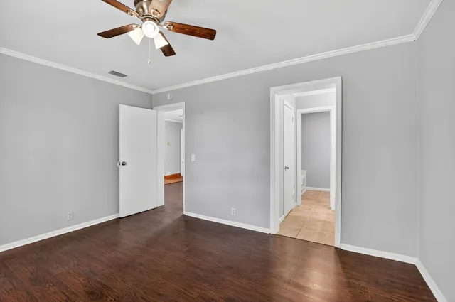 a view of an empty room and wooden floor