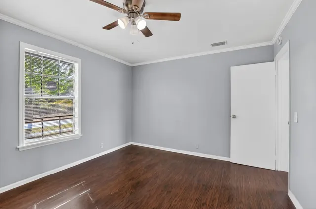 a view of a room with wooden floor and windows