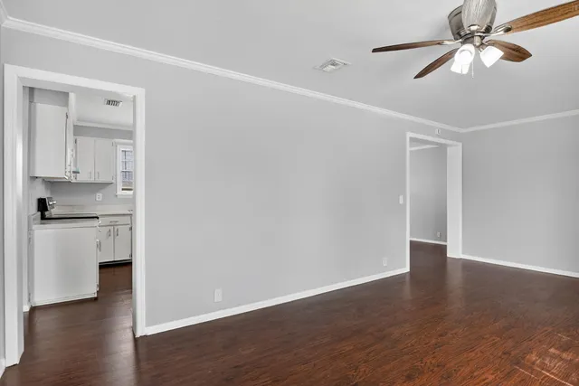 a view of a kitchen with wooden floor and a ceiling fan
