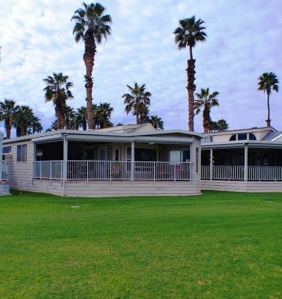 754 Ave 44, Unit 754 Indio, CA 92203 - Photo 42 of 50 a front view of a house with a garden and yard