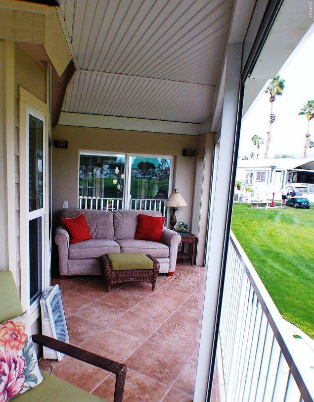 754 Ave 44, Unit 754 Indio, CA 92203 - Photo 10 of 50 a balcony with furniture and a garden