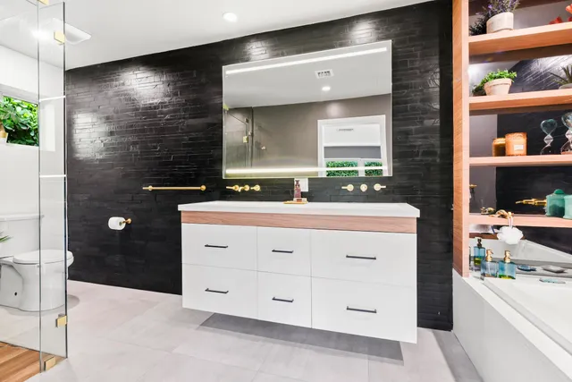 a bathroom with a sink a vanity and a mirror