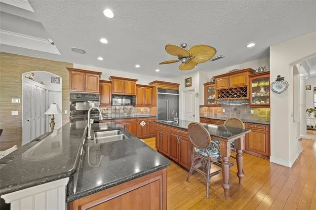 a dining room with furniture a chandelier and wooden floor