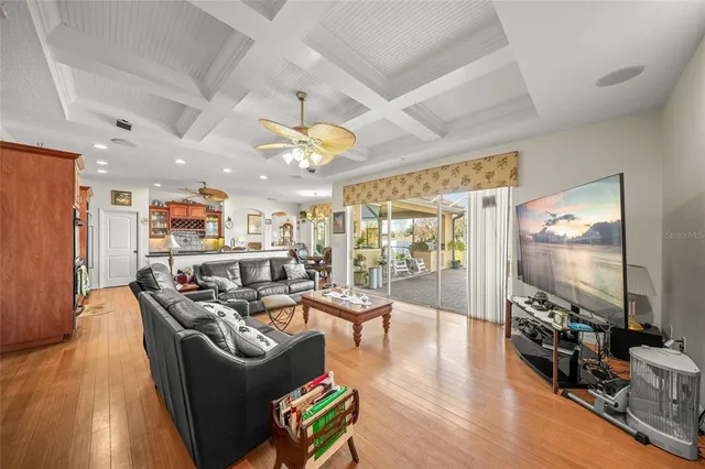 a living room with furniture a large window and a flat screen tv
