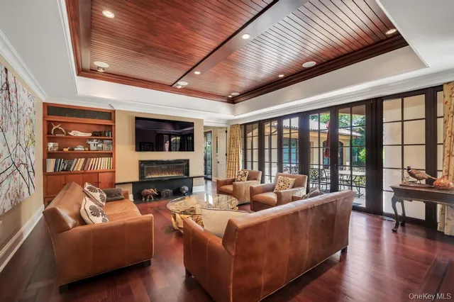 a living room with fireplace furniture and a floor to ceiling window