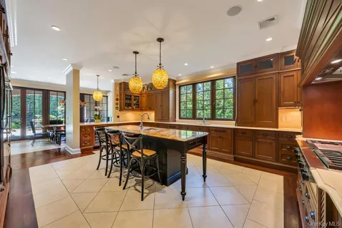 a kitchen with stainless steel appliances kitchen island granite countertop a table and chairs