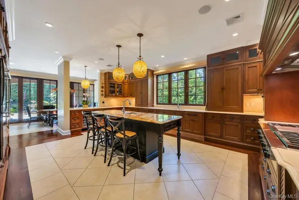 a kitchen with stainless steel appliances kitchen island granite countertop a table and chairs