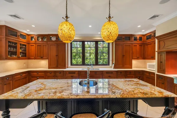 a bathroom with a granite countertop sink and a bathtub
