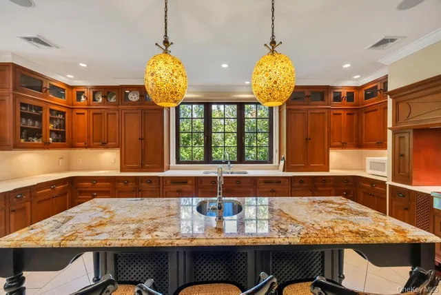 a bathroom with a granite countertop sink and a bathtub