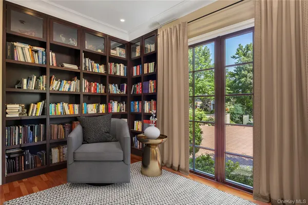 a living room with furniture and a book shelf