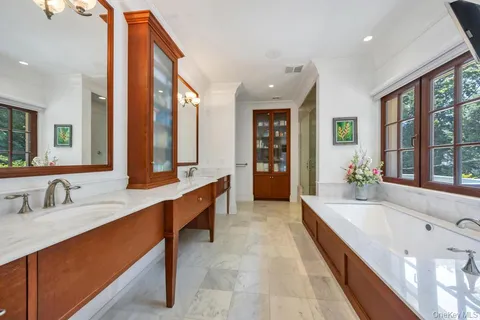 a large bathroom with a large tub and sink