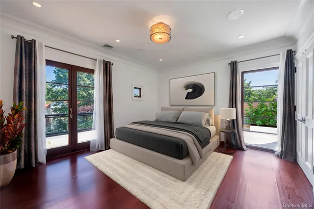 a bedroom with a large bed and a view of balcony