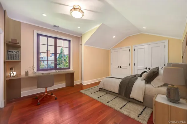 a spacious bedroom with a large bed and a window