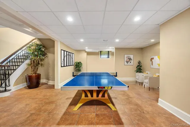 a living room with furniture a table and a potted plant