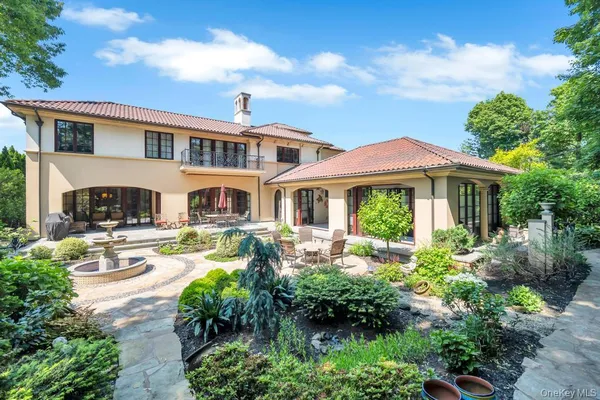 a front view of a residential houses with yard and green space