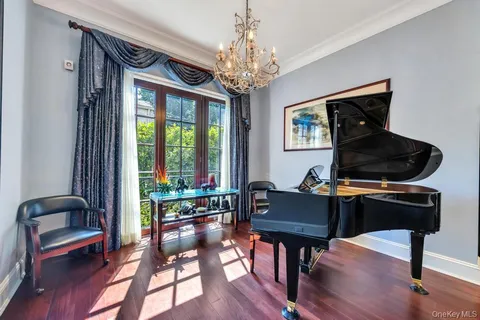 a living room with furniture and a chandelier