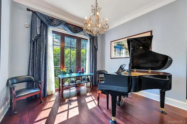 a living room with furniture and a chandelier