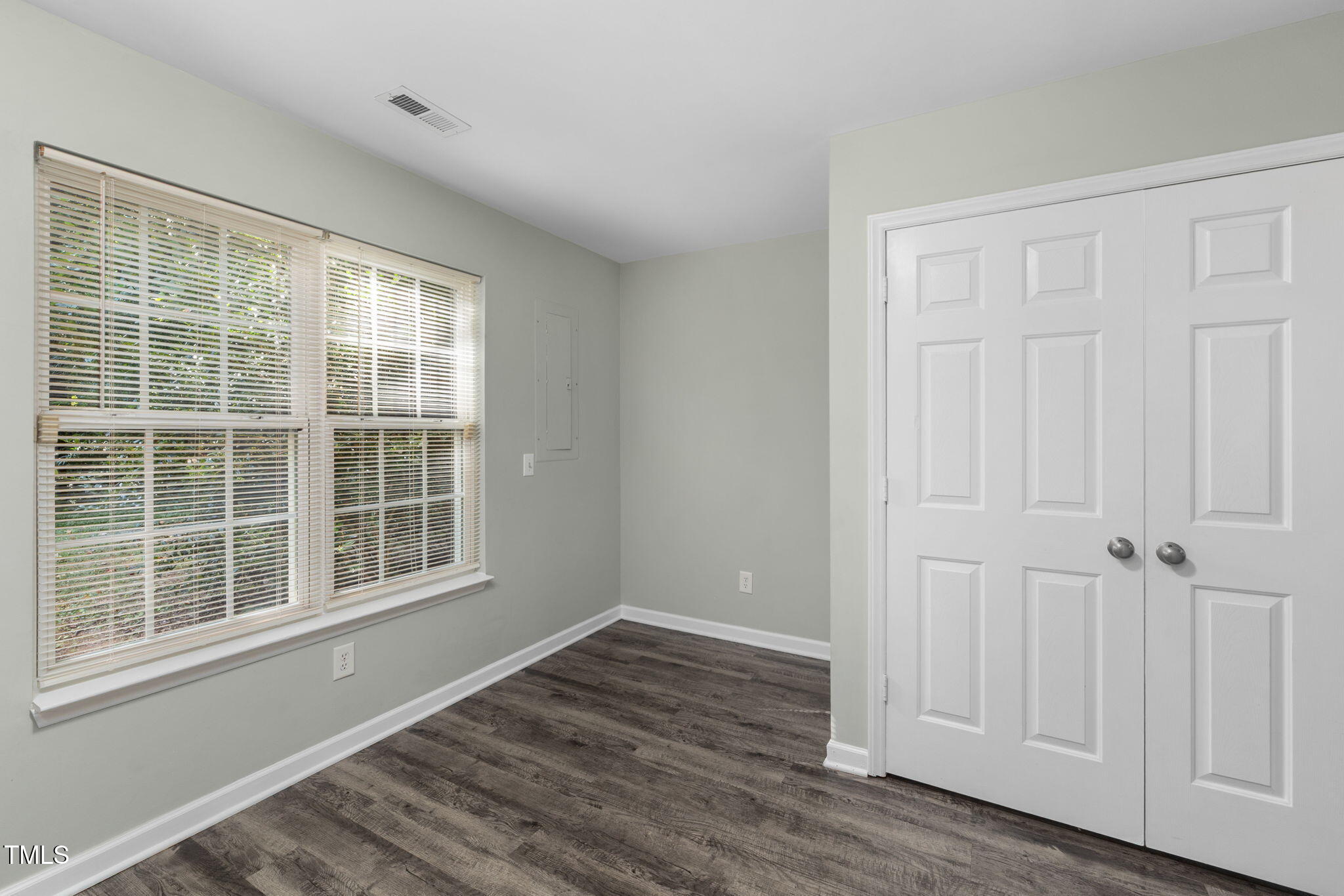 67 Red Lane Raleigh, NC 27606 - Photo 10 of 33 an empty room with wooden floor and windows