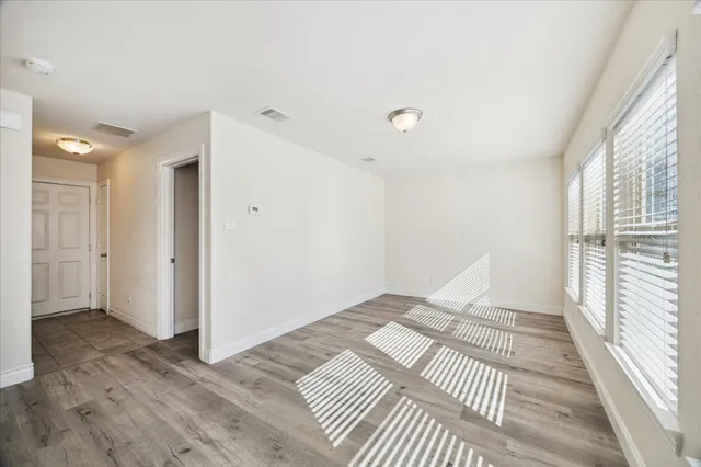 a view of a bedroom with wooden floor and bedroom