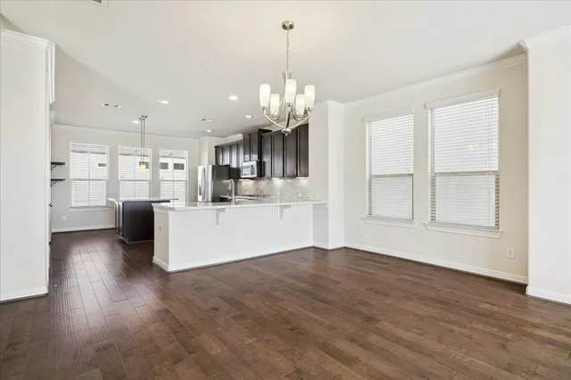 a view of a kitchen with cabinets and wooden floor
