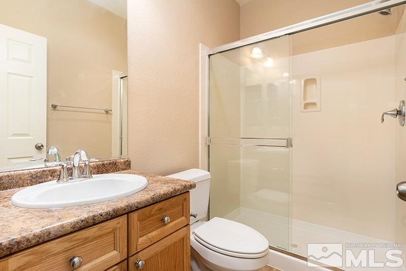 2010 Long Hollow Drive Reno, NV 89521 - Photo 12 of 24 a bathroom with a granite countertop sink toilet and shower